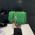 Green quilted crossbody bag with stylish gold chain strap and elegant metal clasp for women. - Green