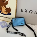 Mini suitcase crossbody bag in glossy blue, featuring stylish vertical grooves and shoulder strap. - Blue