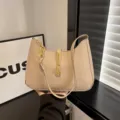 Stylish beige leather underarm shoulder bag for women, chic metal lock and chain detail. - Khaki