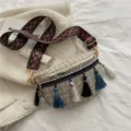 Ethnic style woven crossbody bag for women with colorful tassels and wide shoulder strap. - White