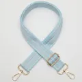 Adjustable wide bag strap in light blue and silver striped webbing with gold hardware. - Style 756