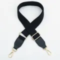 Adjustable black canvas bag strap with gold hardware, replacement shoulder strap accessory. - Black Strap with Black Accent