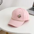 Detailed close-up of the pink kids baseball cap featuring sparkling rhinestone bow and chain decor. - 54cm Adjustable / Pink
