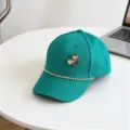 Detail view of children baseball cap with rhinestone bow and sparkling chain decoration. - 54cm Adjustable / Green