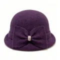 Detail shot of the purple wool blend cloche hat with an elegant bow and crystal buckle. - M (56-58cm) / Purple