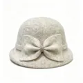 Close-up of the elegant wool-blend cloche hat featuring a large knit bow and sparkling rhinestone. - M (56-58cm) / Beige