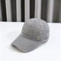 Detail shot of a grey knit hollow out baseball cap with shell pattern and rhinestone heart logo. - Adult Model, 54-59cm Adjustable / Gray