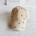 Closeup of beige waffle baseball cap featuring cute red cherry ornaments and shiny rhinestones. - Cherry / Adult Adjustable / Khaki