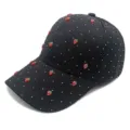 Close-up detail of black waffle baseball cap with cute red strawberries and starry studs. - Strawberry Decoration / Adult Adjustable / Black