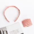 Detailed view of the pink folding telescopic hair hoop and comb set, compact and portable. - Pink