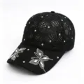 Close-up of black hollow knit baseball cap featuring sparkling rhinestone butterfly details. - 54-59cm Adjustable / Black