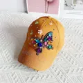 Detailed view of the stylish yellow rhinestone butterfly baseball cap, fashion sun hat for women. - One Size / Orange