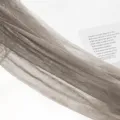 Grey sheer hosiery fabric detail view, lightweight translucent mesh stocking material. - Gray