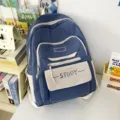 Stylish blue canvas school backpack with white contrast design and front pocket for daily use. - Blue
