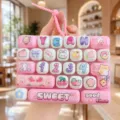 Close up of pink cute stress relief keyboard keychain with cartoon print and numbers. - Cute Pet Stress Relief Keyboard (Pink Rabbit Diary)
