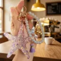 Detailed view of summer ocean style starfish pearl bracelet keychain, resin pendant charm accessory. - Purple