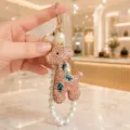Crystal rhinestone giraffe keychain and pearl bag charm detail view, elegant accessory. - Rhinestone Giraffe with Pearl Chain Style / Champagne