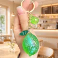 Exquisite green lemon acrylic jelly keychain detail, sparkling crystal pendant for chic bags. - Acrylic Jelly Lemon (Green)