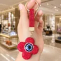 Red rhinestone evil eye clover keychain detail, sparkling crystal bag charm and ring hook. - Red