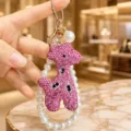 Close-up detail of the pink rhinestone giraffe keychain showing sparkling crystals and pearl strap. - Rhinestone Giraffe with Pearl Chain Style / Pink