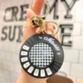Detail shot of mini piano keychain with numbered keys and bell, decompression music toy. - Girl Round Piano (Black)