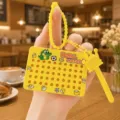 Magnetic bead drawing board keychain with cute crown stylus and cartoon pattern design. - Yellow Dinosaur