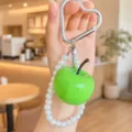 Cute green apple keychain with pearl strap and heart carabiner, resin fruit bag charm accessory - Cyan Apple