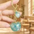 Cute acrylic persimmon keychain and bag charm with iridescent green finish, lovely fruit accessory. - Acrylic Good Things Happen (Mint Green)