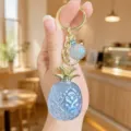 Cute blue pineapple keychain bag charm with gold hardware, stylish acrylic fruit accessory for keys. - Acrylic Colorful Pineapple (Blue)