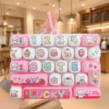 Cute pink keyboard decompression toy keychain with adorable cartoon keycaps and letters. - 26-Key Stress Relief Keyboard (Pink Cat Diary)