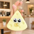 Detail view of the cute yellow cheese squeeze keychain with funny big eyes and bubble. - Cheese Dessert Bubble Blowing