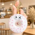Cute donut squishy keychain with bubble blowing design, soft silicone novelty toy for bags. - Donut Dessert Bubble Blowing