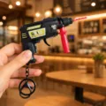 Mini electric drill shape keychain creative decompression toy with sparkling flint gear design. - Electric Drill Gun (Black)