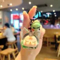 Cute acrylic quicksand keychain with cute doll pendant and green bell, perfect bag charm. - Green