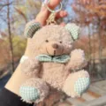 Close-up of a cute fluffy teddy bear plush keychain with green checkered bow and details. - Khaki Plaid Bowknot Bear