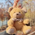 Cute brown teddy bear plush keychain with plaid bow detail, perfect bag charm gift accessory. - Brown Plaid Bowknot Bear