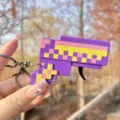 Mini pixel flint gun keychain with rotating gear and spark effect, creative decompression toy. - Block Flint Gun (Purple)