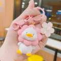 Cute resin sunflower duck keychain detailed closeup, sweet pink cartoon bag charm pendant. - Pink Flower Duck