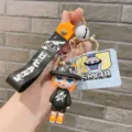 Close-up of cute cartoon PVC keychain pendant with liquid capsule and letter strap accessory. - Black Monster