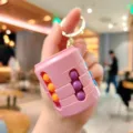Pink cylinder magic bean puzzle keychain fidget toy rotating stress relief toy cute bag pendant - Pink