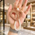 Korean style rhinestone hollow heart keychain with elegant pearl strap for exquisite bag pendant. - Champagne