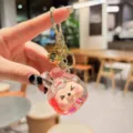 Close-up transparent acrylic quicksand keychain with glitter and cute cartoon character pendant. - Glitter My Melody (Red)