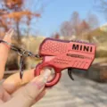 Mini flint gun keychain, red metallic decompression toy keyring with gear and spark design for kids. - Metallic Flint Gun (Red)