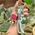 Detailed view of cute toast bread keychain with braided mint lanyard and cartoon charm. - Green Lanyard Blueberry Jam Toast / Green