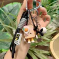 Cute toast bread keychain with braided lanyard and cartoon charms for school bags and phones. - Black
