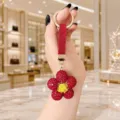 Red rhinestone sunflower keychain detail, sparkling crystal daisy bag charm pendant close-up. - Red Rhinestone Flower