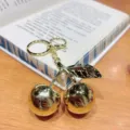 Exquisite gold metallic cherry keychain detail, stylish car bag pendant charm for women and girls. - Gold Metallic Cherry