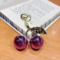 Dazzling purple cherry keychain, glossy metallic finish with gold leaves and ring pendant. - Purple Metallic Cherry