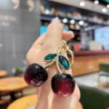 Exquisite crystal cherry keychain bag charm, stylish metal fruit pendant for women use. - Black Red Iridescent Green Leaf Cherry