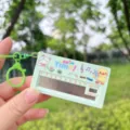 Mini electronic piano keychain detail view, cute duck pattern and music notes, portable toy design. - Green Duckling